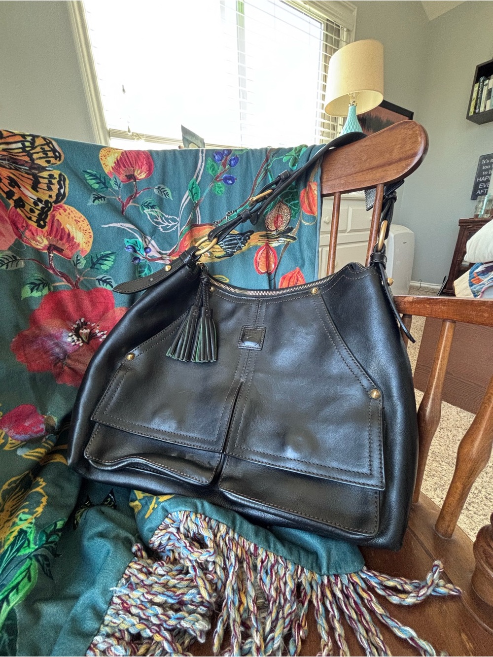 Dooney & Bourke Florentine leather Kingston hobo bag is featured in black.